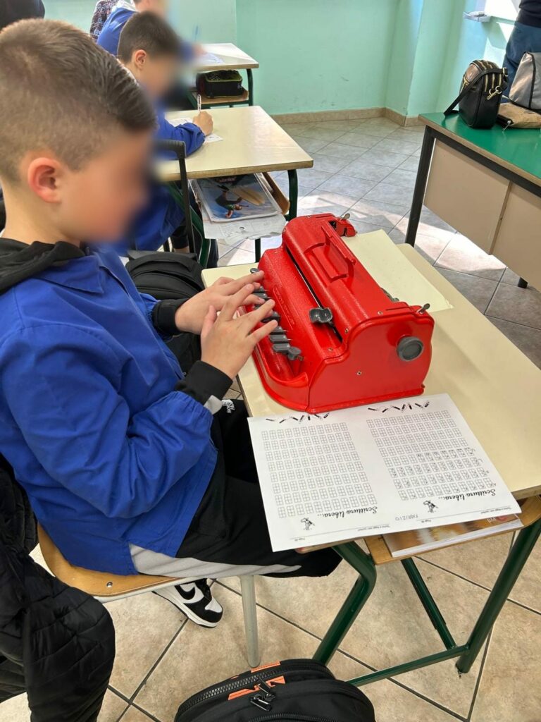 Un bambino apprende l'utilizzo della Dattilobraille.